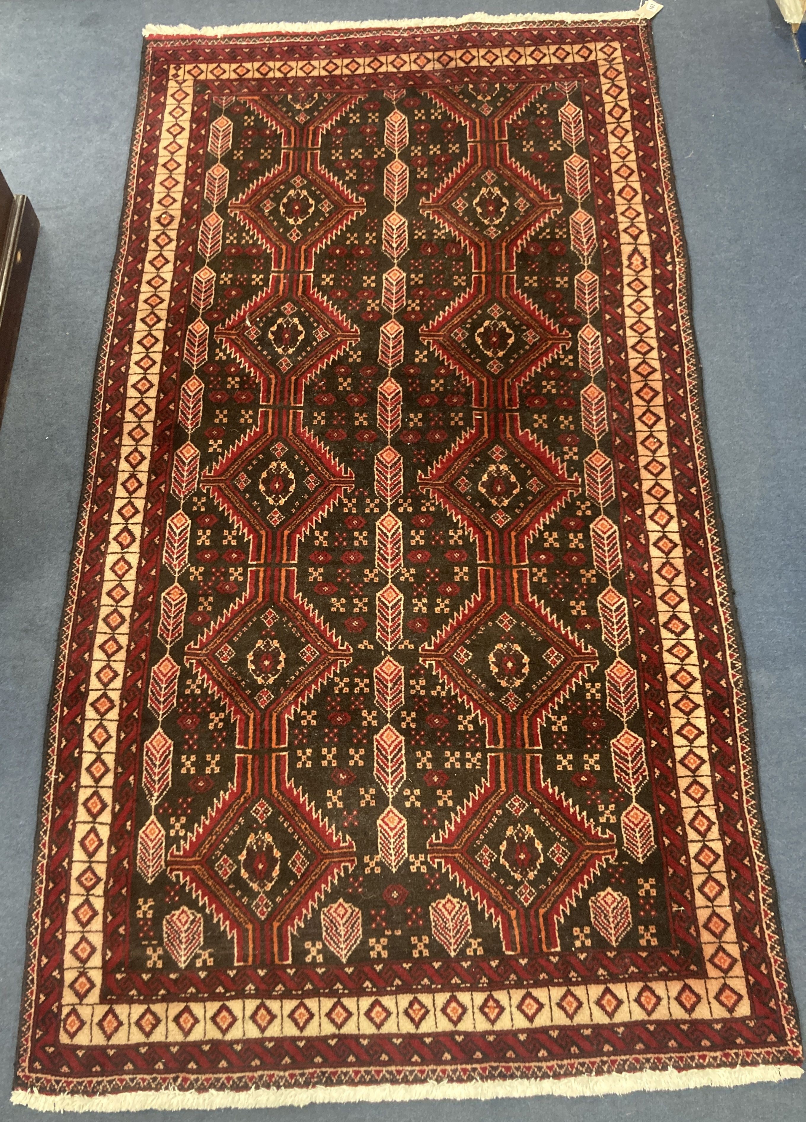 A Bakhtiari red ground rug, 210 x 110cm 210 x 110cm